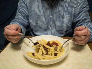 Midsection of man having food in plate