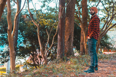 Rear view of man standing in forest