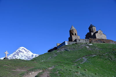 Low angle view of mountain against clear blue sky