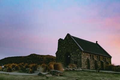 House on a field against sky