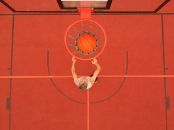 Low angle view of basketball hoop against brick wall