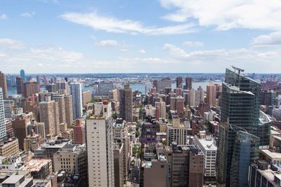 High angle view of modern buildings in city against sky