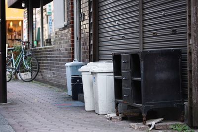 Bicycle parked on footpath by building