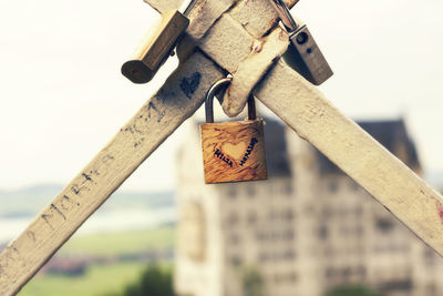 Close-up of padlocks hanging on wood