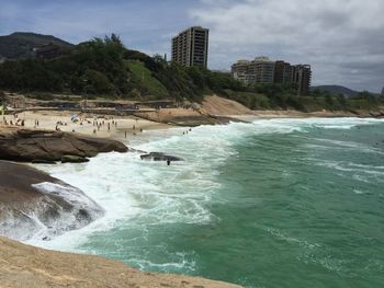Scenic view of beach and city against sky
