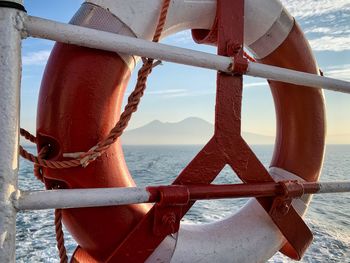 Life belt hanging on railing in ship