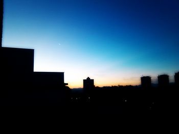Buildings in city at sunset