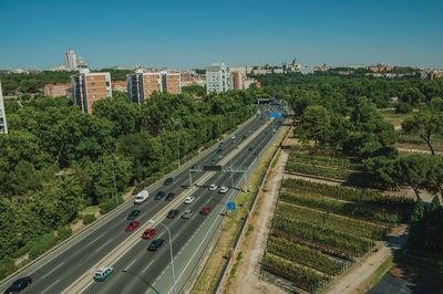 Multi-lane highway with heavy traffic in the midst of trees and buildings in madrid, spain.