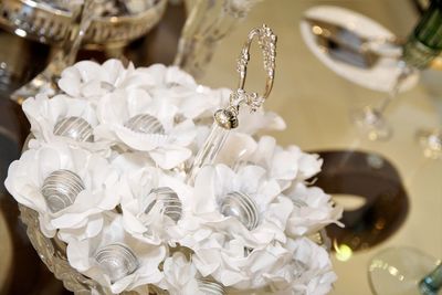 Close-up of wedding rings on white flowers