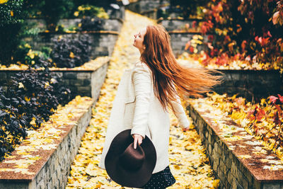 Rear view of woman standing by railing