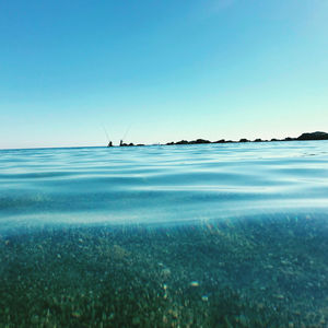 Scenic view of sea against clear blue sky