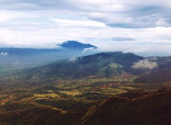Scenic view of mountains against cloudy sky