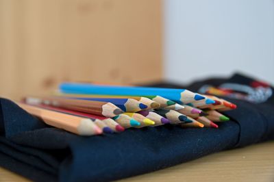 Close-up of multi colored pencils on table