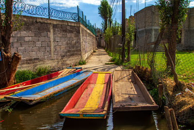 View of boats moored in river against building