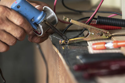 Close-up of person working on machine