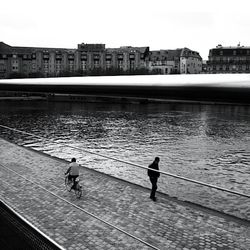 People in front of river