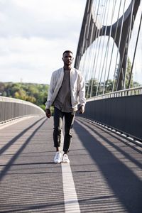 Full length of man on footbridge