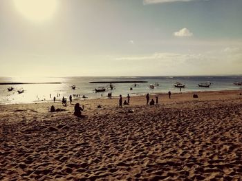 People on beach against sky