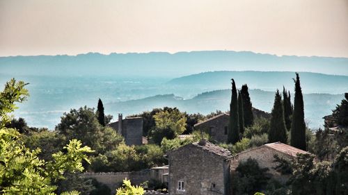 Panoramic view of trees and buildings against sky