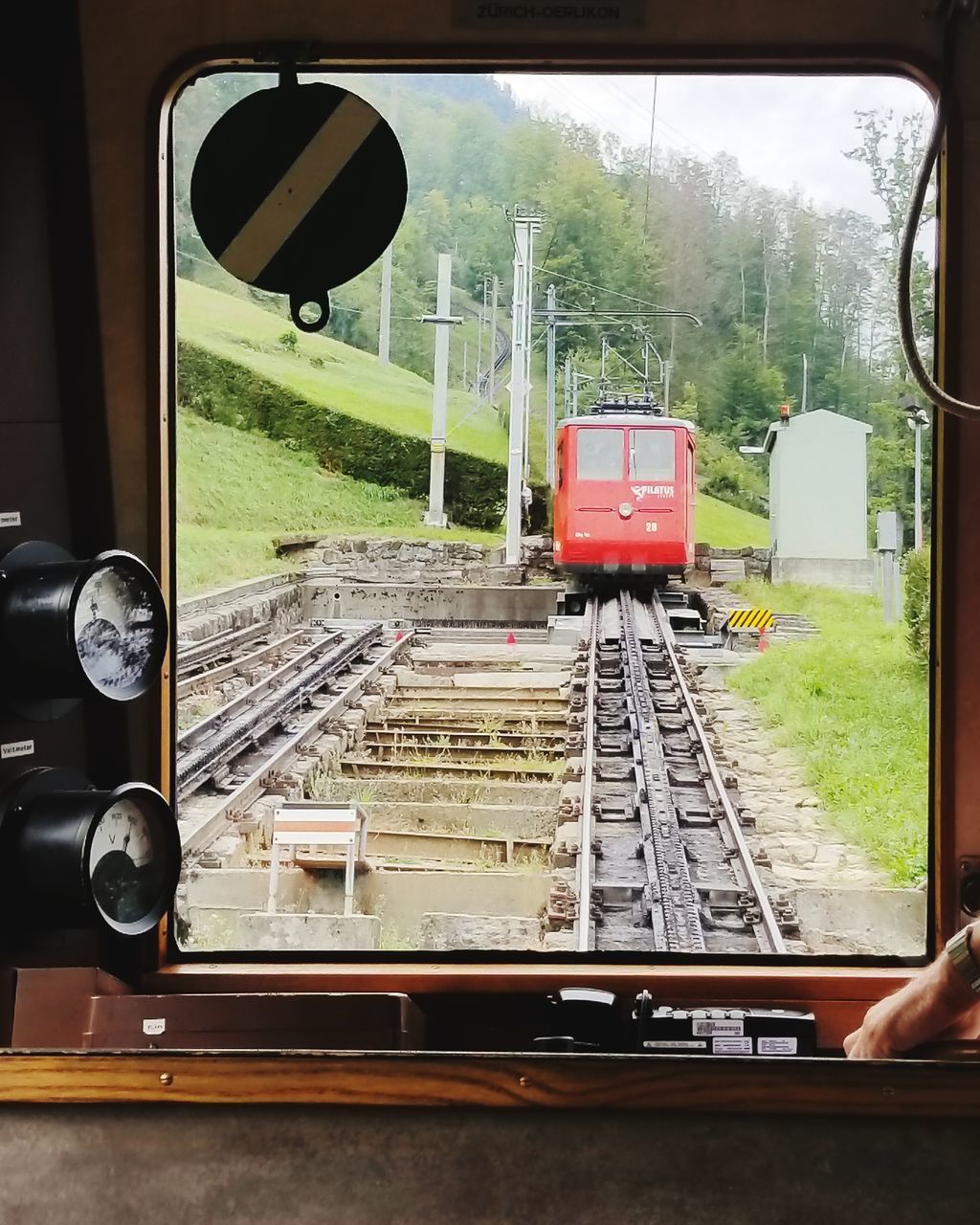 TRAIN ON RAILROAD TRACKS SEEN THROUGH WINDOW