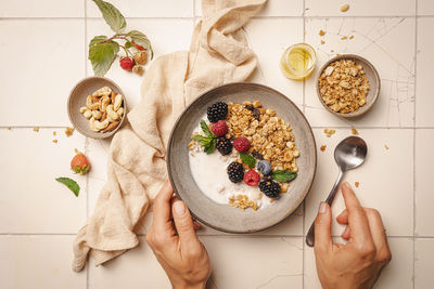 Cropped hand of person holding food on table