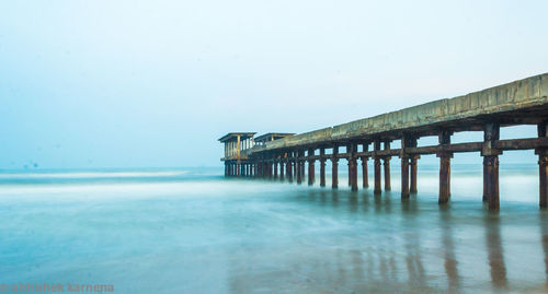 Pier over sea against clear sky