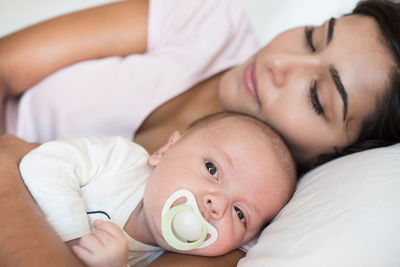 Portrait of cute baby lying on bed