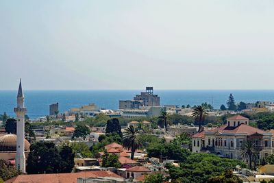 High angle view of buildings and sea against sky