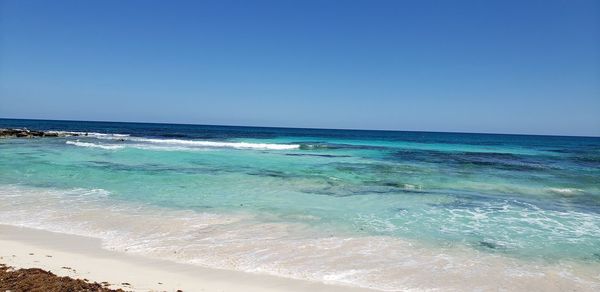 Scenic view of sea against clear blue sky