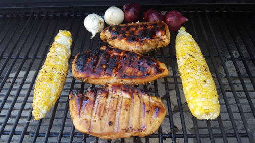 High angle view of meat on barbecue grill