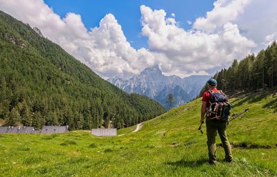 Rear view of man on mountain against sky