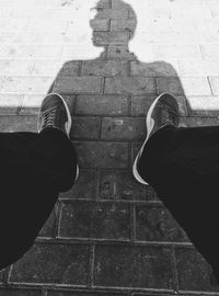 Low section of people standing on tiled floor