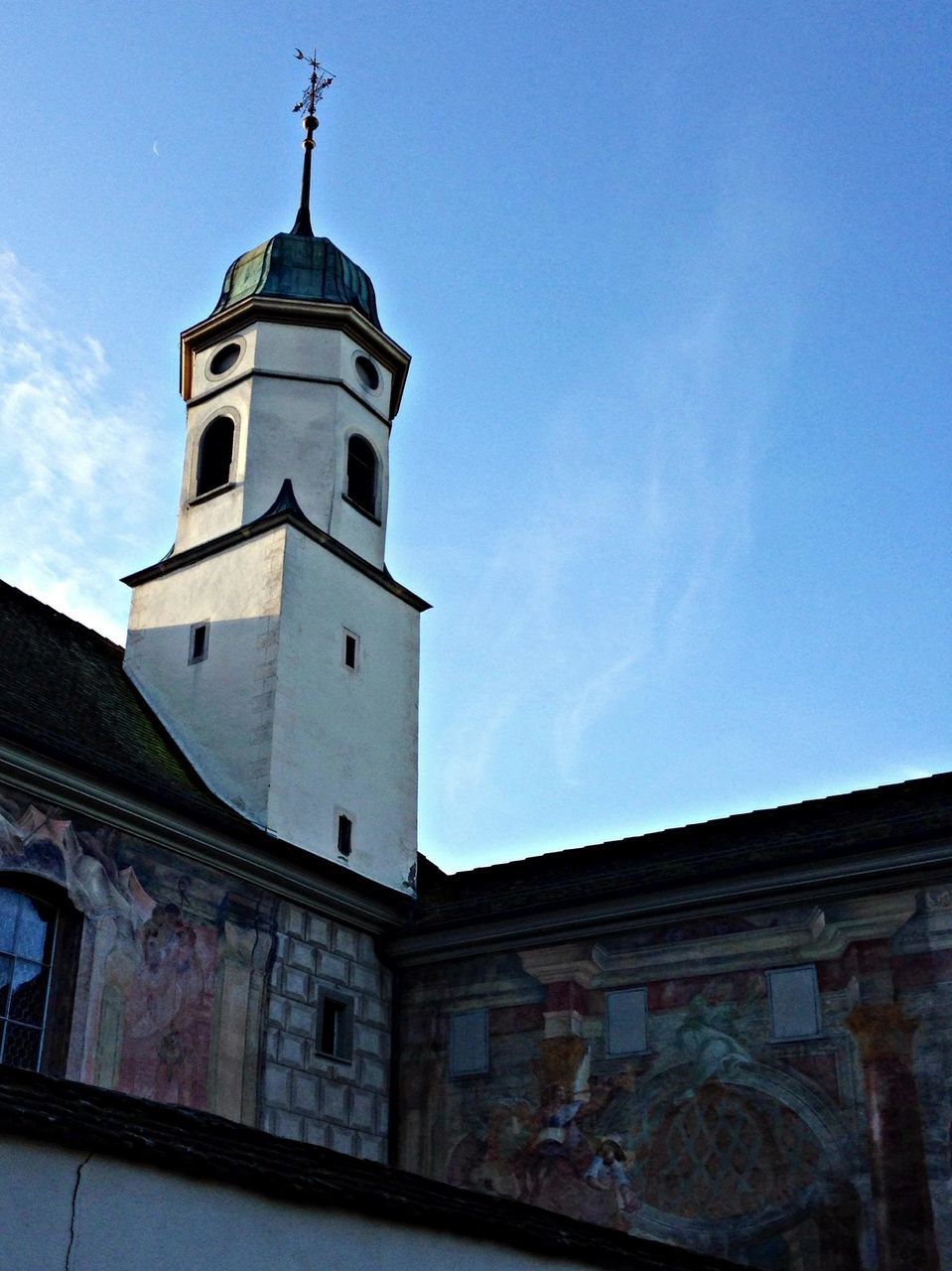 building exterior, architecture, built structure, low angle view, church, religion, place of worship, sky, spirituality, cross, blue, tower, high section, day, outdoors, no people, clear sky, sunlight