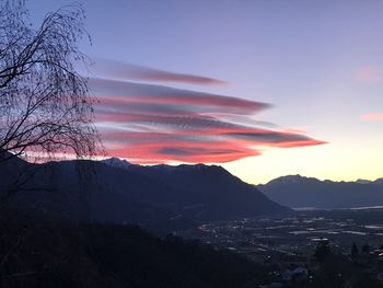 Scenic view of mountains against orange sky