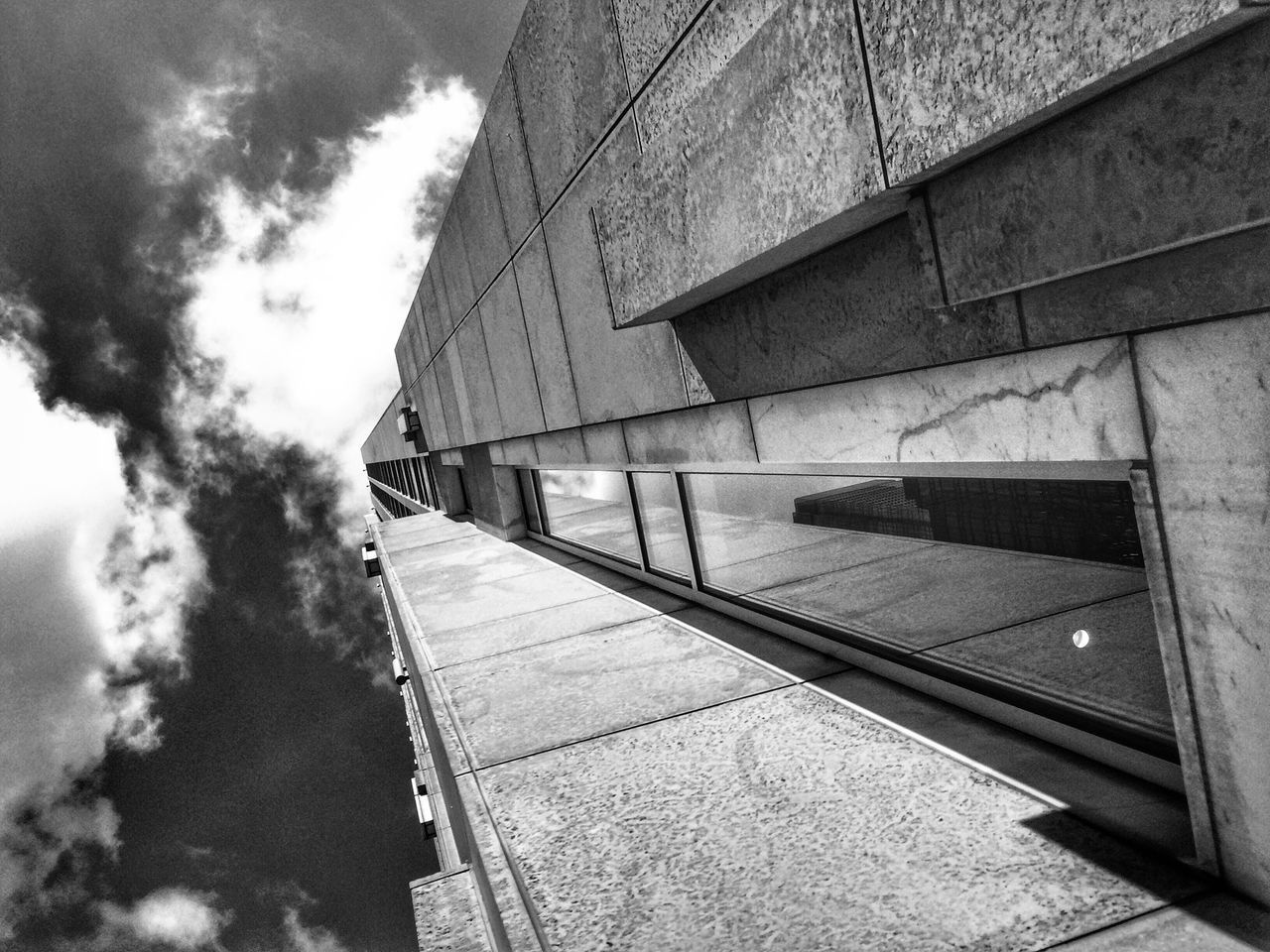 DIRECTLY BELOW SHOT OF BUILDINGS AGAINST SKY