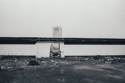 Abandoned building on field against clear sky
