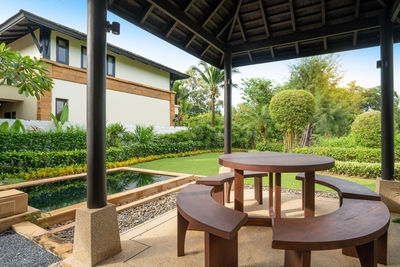 Chairs and table in lawn by building