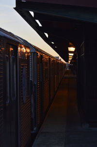Train at railroad station during sunset