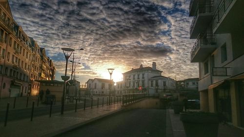 City street against cloudy sky