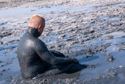 Low section of man swimming in sea