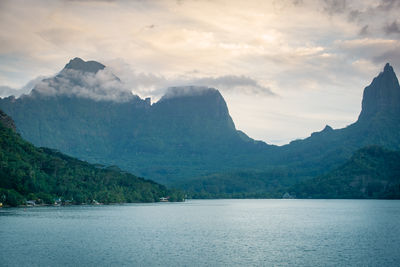 Scenic view of sea and mountains against sky