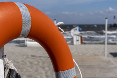Close-up of umbrella on beach against sky