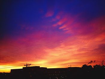 Silhouette of building against dramatic sky