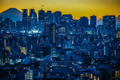 High angle view of illuminated city buildings at night