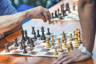 Midsection of man playing chess