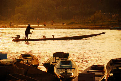 Boat in river at sunset