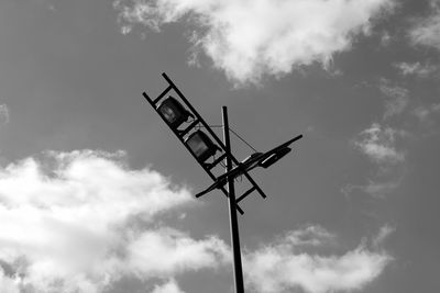 Low angle view of halogen lights against sky