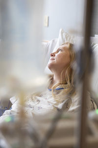 Mature patient lying on bed in hospital