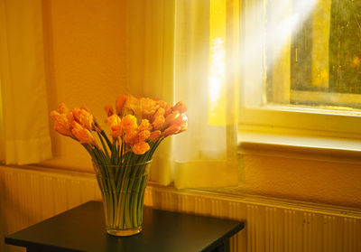 Flowers in vase on table at home