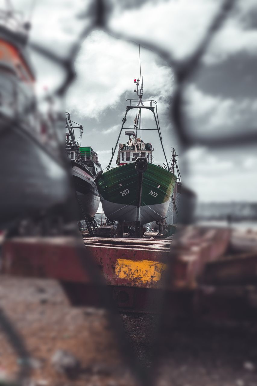 CLOSE-UP OF DRINK AGAINST BOAT